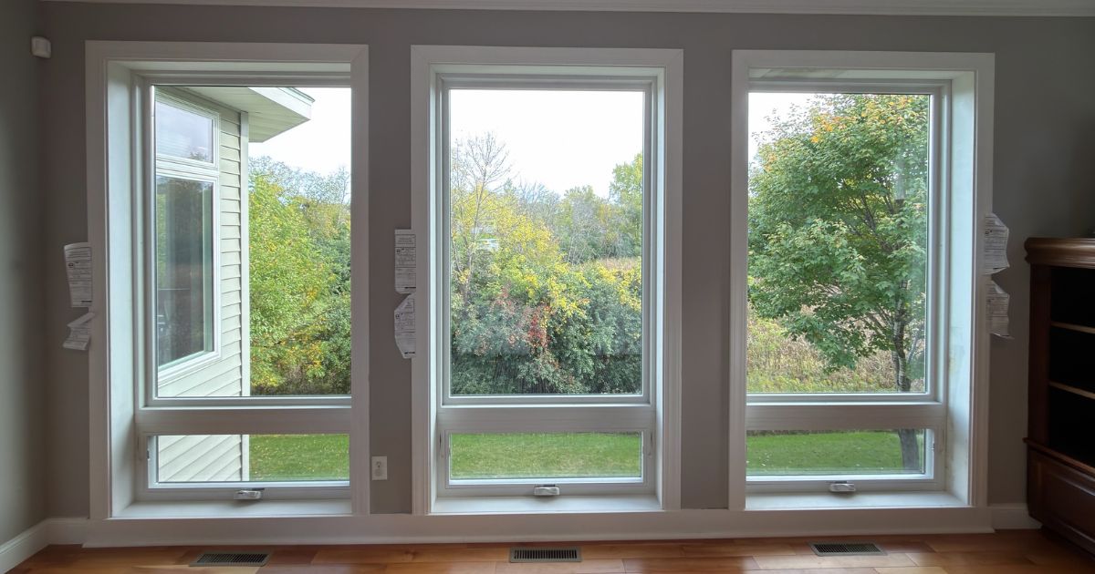 Interior view of three new Andersen 100 Series picture over awning windows with white trim